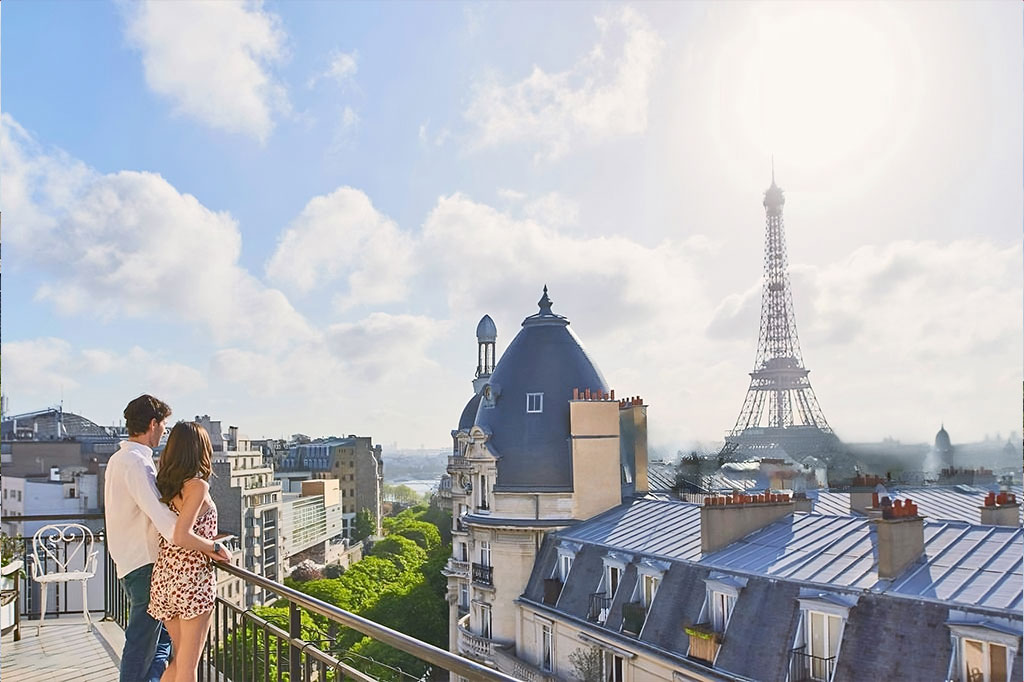 Jeune couple sur une terrasse qui regarde les toits de Paris avec la Tour Eiffel - Fiscalité patrimoniale